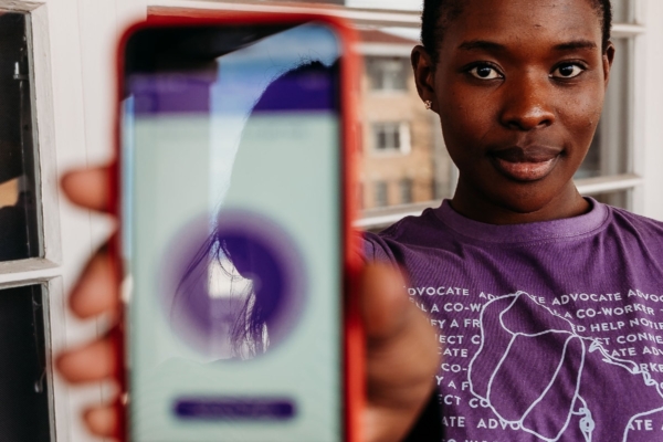 Woman holding phone to show application