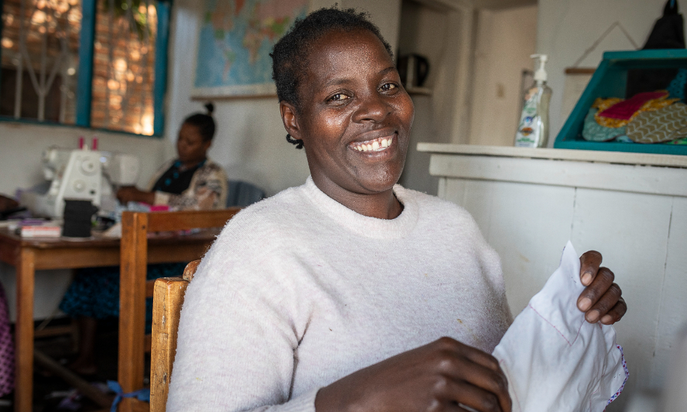 person smiling and holding fabric