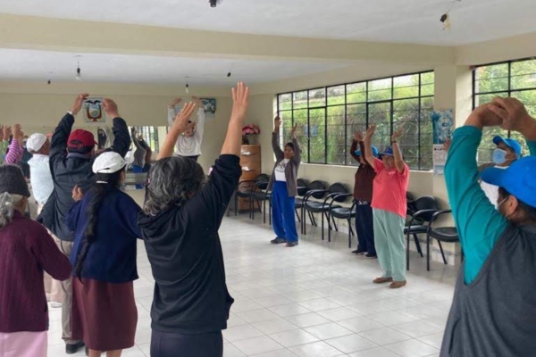 Volunteers and locals stretching indoors