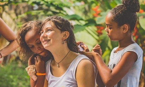 local children cling to the volunteer