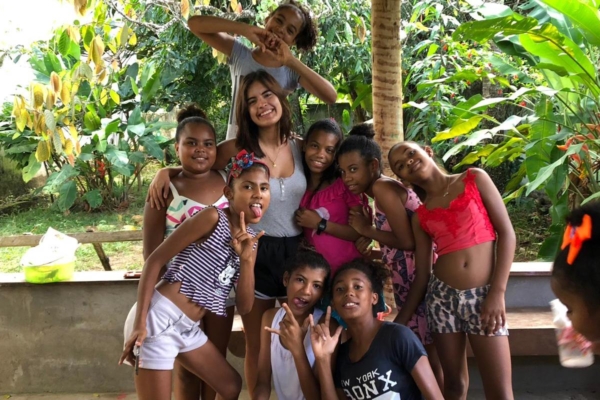 local kids posing for a photo with a volunteer