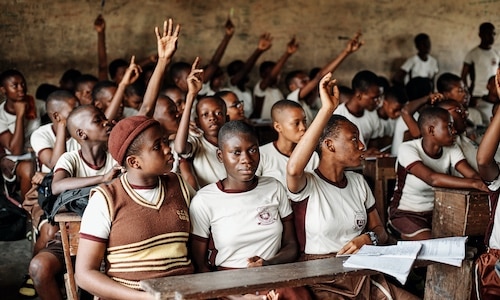 a group of young children sitting in a classroom in Ghana