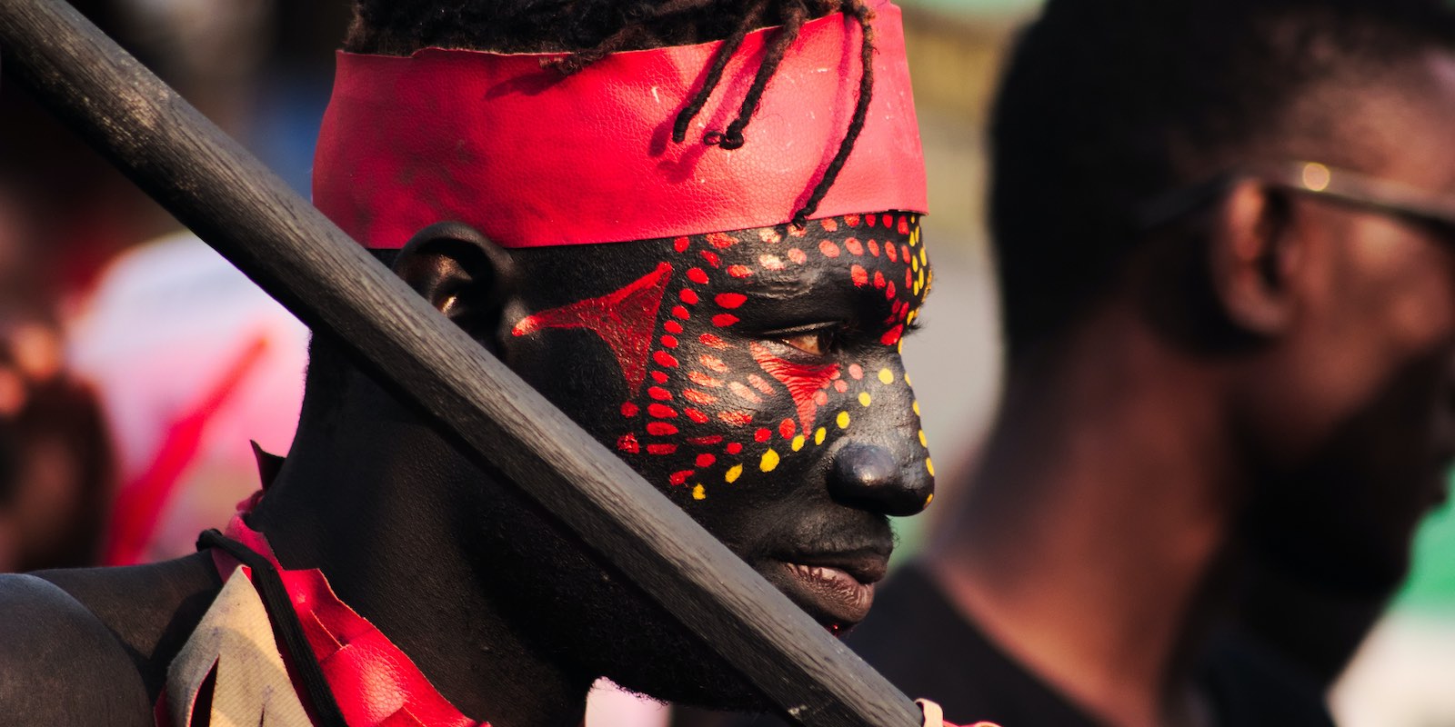 local man wearing face paint and traditional clothes in Ghana