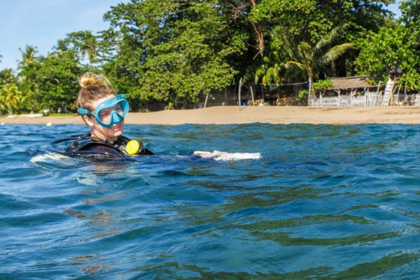 a person in a wet suit and goggles in the water