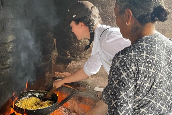volunteer and local cooking in a traditional way