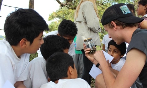 kids looking at a specimen in a jar