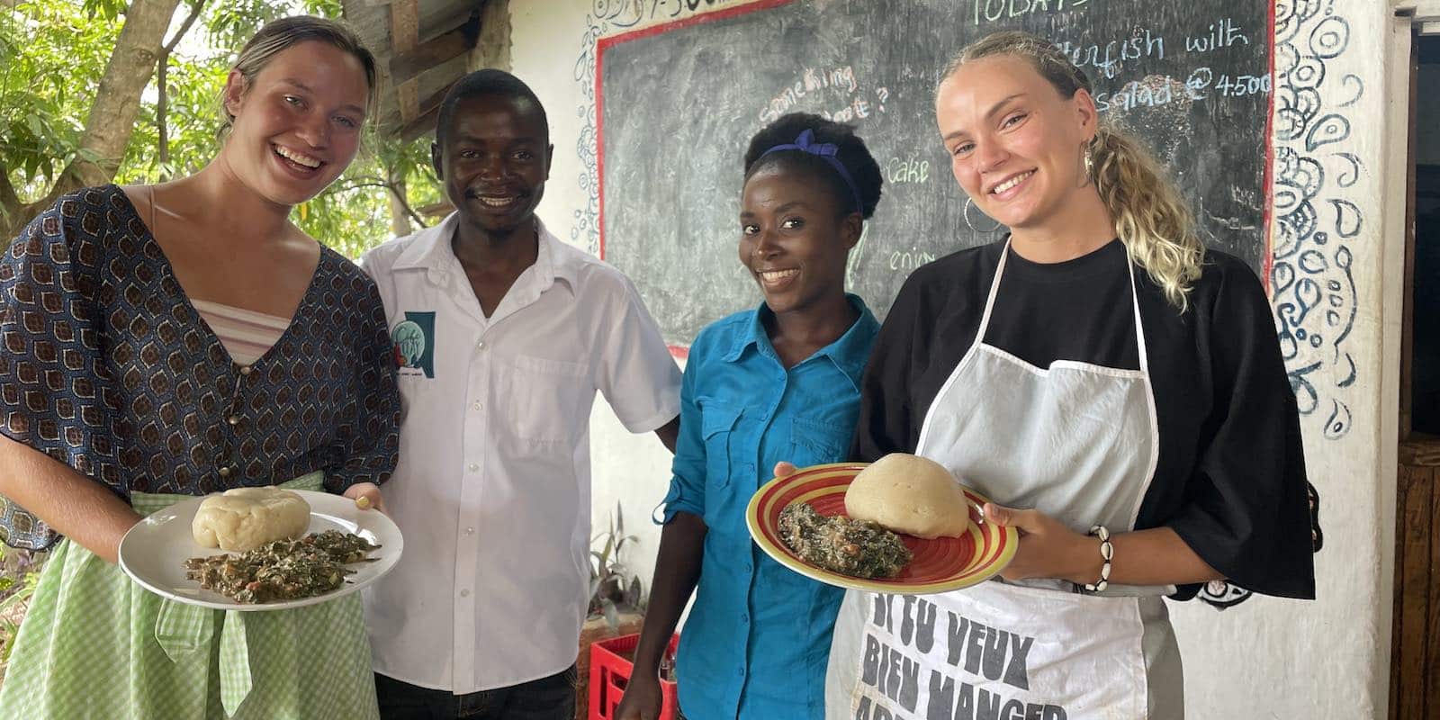 locals and interns holding a food smiling for a photo