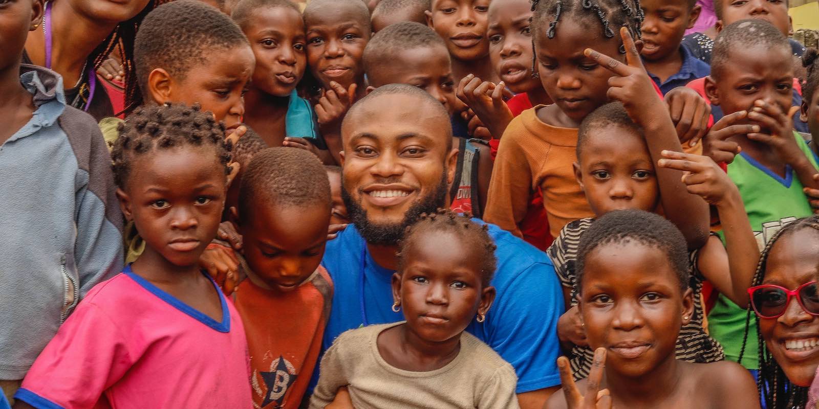 an intern with a group of local children in Zimbabwe