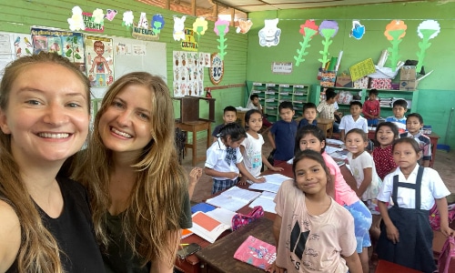 teachers and kids smiling in a classroom