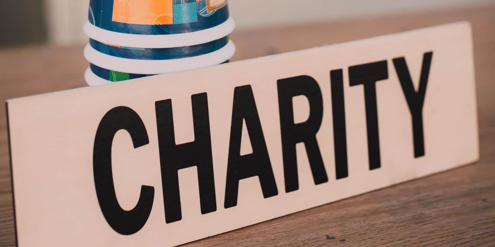 placard that says "charity" on top of the table