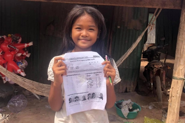 Girl showing piece of paper