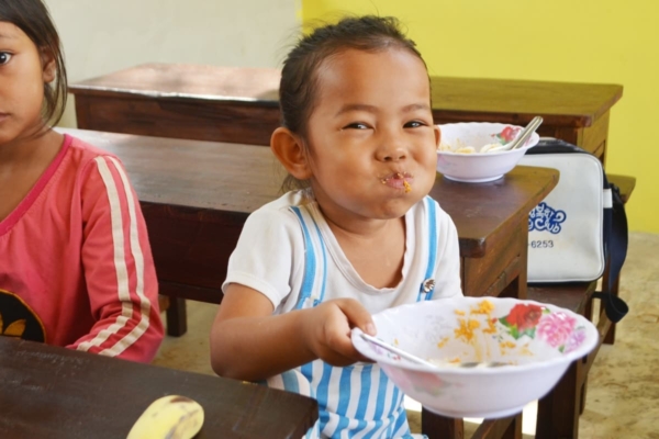 Girl laughing while eating