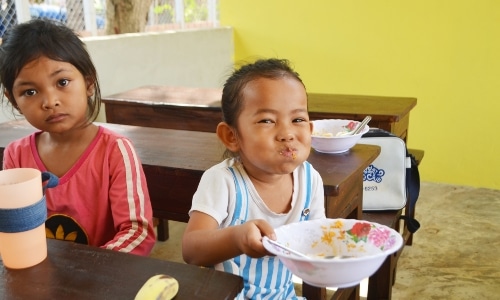 Girl laughing while eating