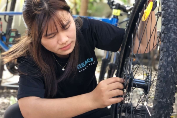 Girl fixing a bike
