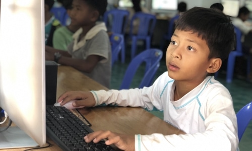 Boy behind computer