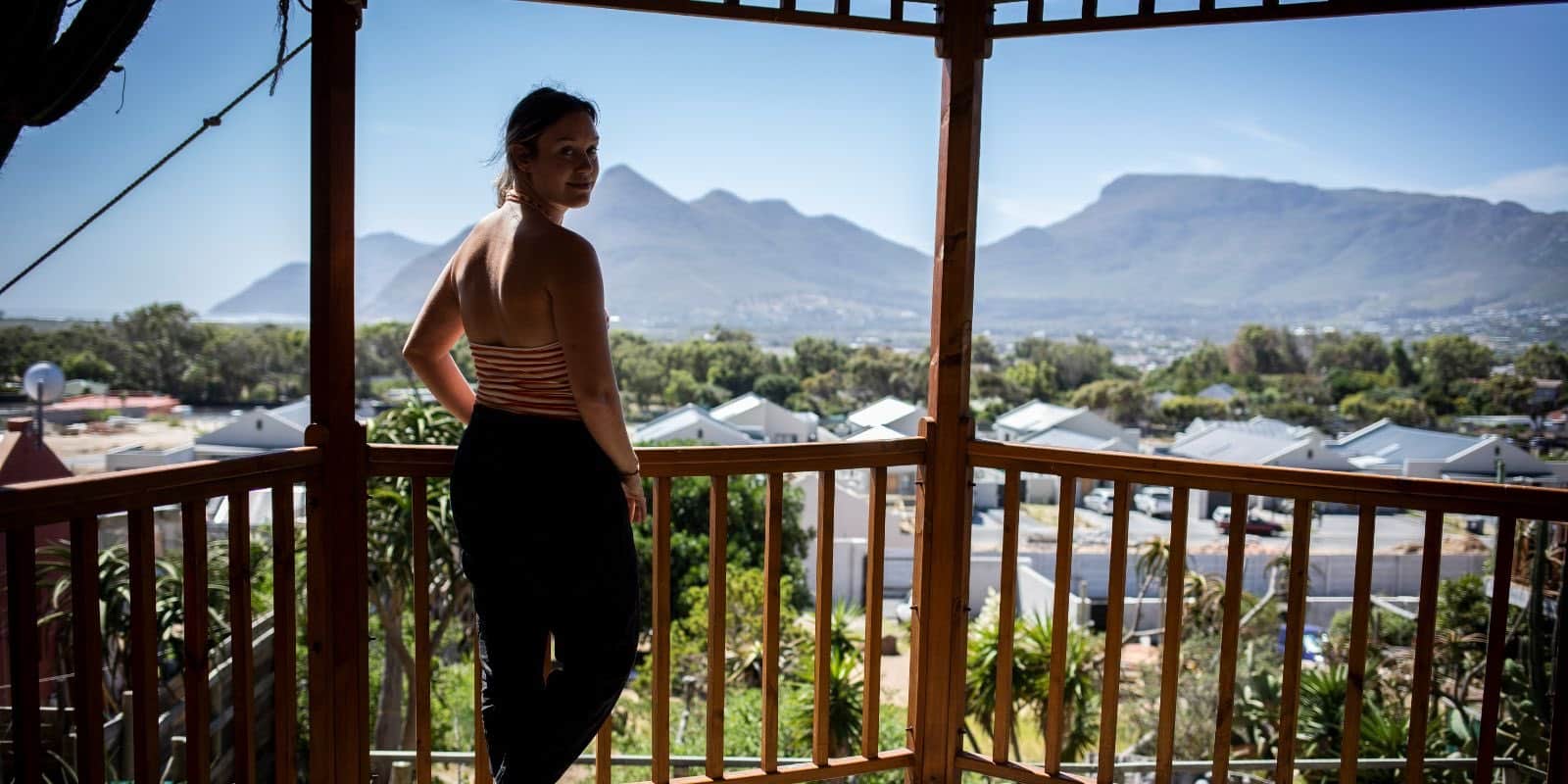 an intern standing on a balcony overlooking a mountain in Cape Town