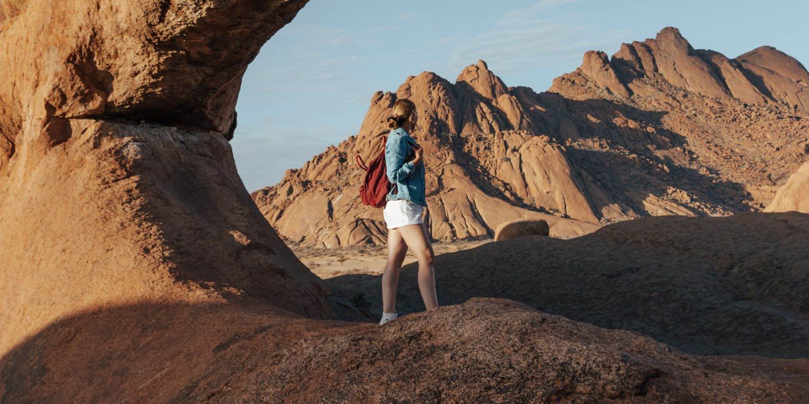 woman standing near the beautiful rock formation