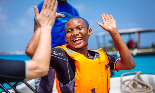 Smiling boy giving high five