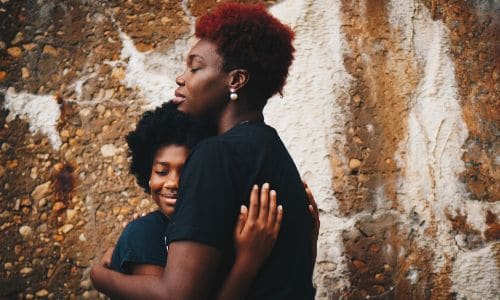 mom and daughter hugging each other