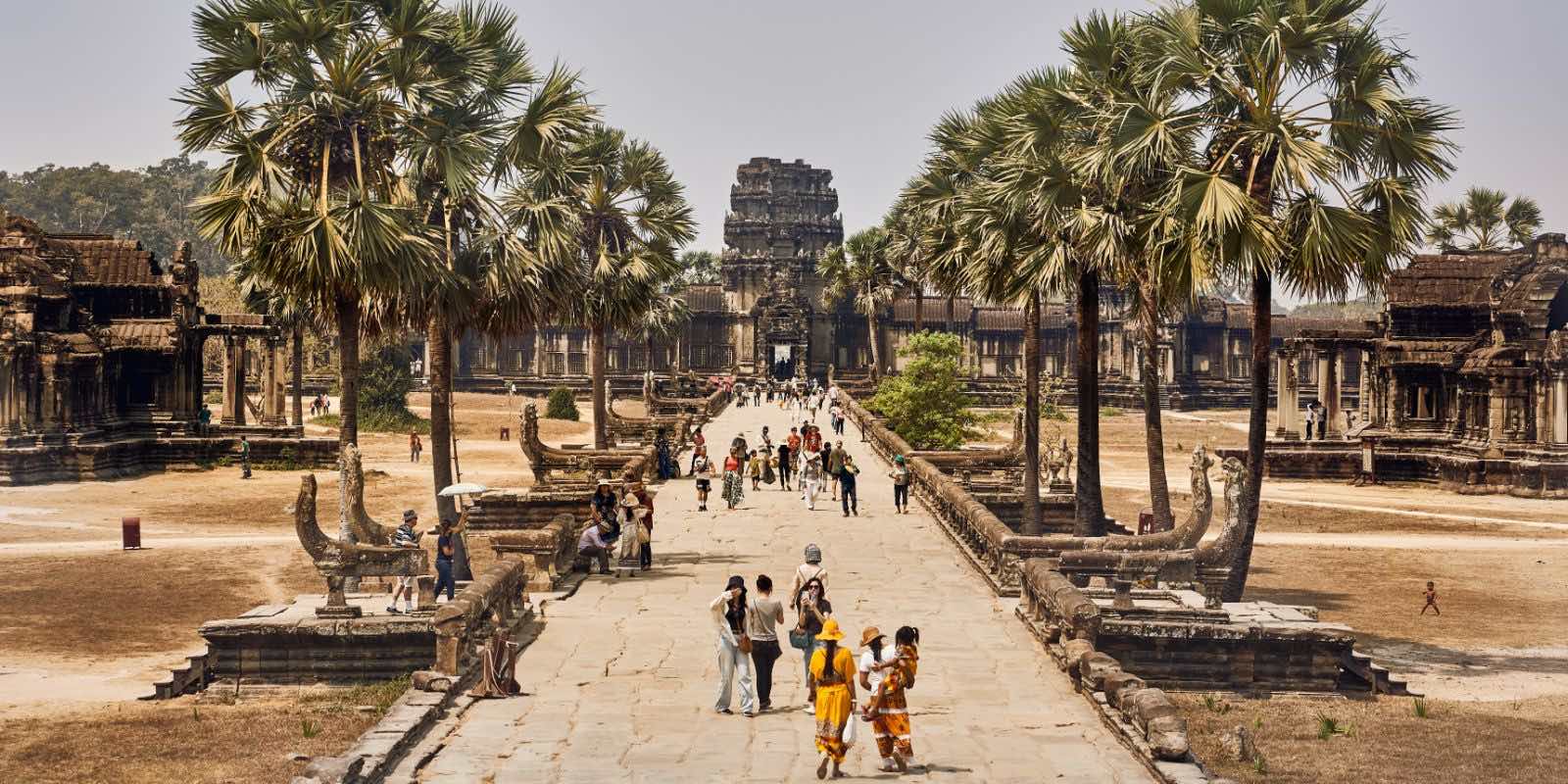 A group of people walking in Angkor Wat, Krong Siem Reap, Cambodia