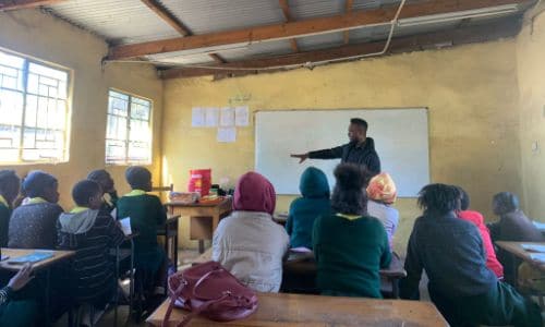 teacher and students in a classroom in Zambia