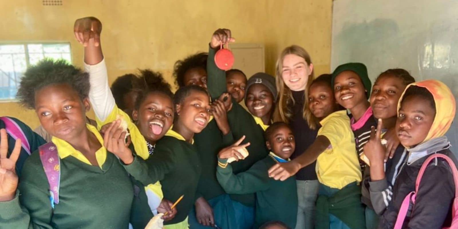 a photo of an intern with students in Zambia