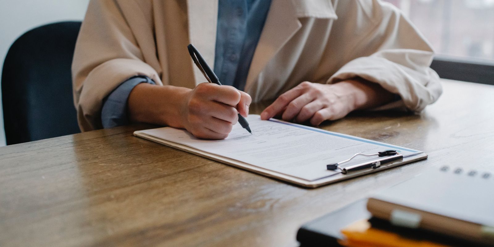 woman writing in clipboard