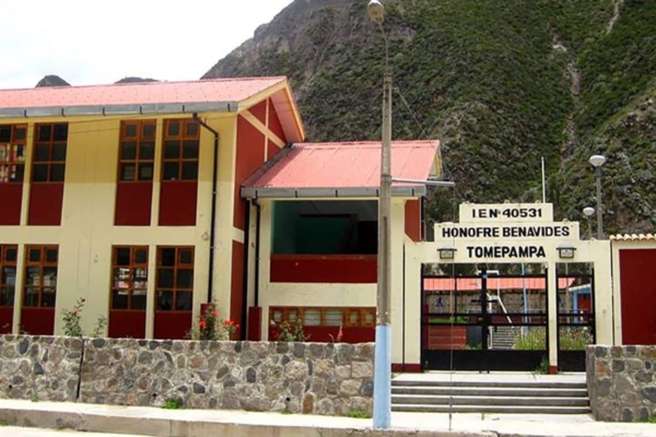 A school building in front of a mountain