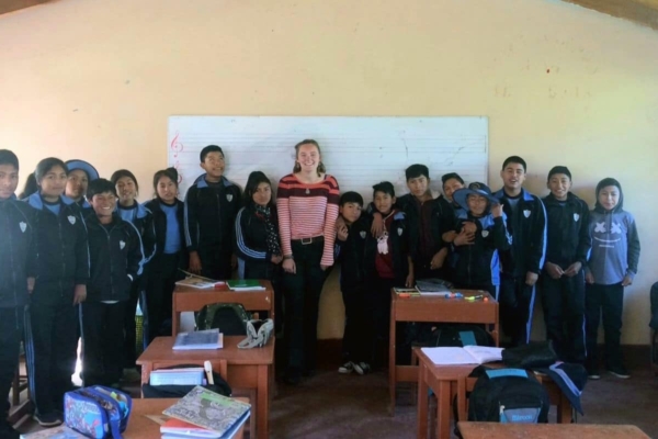 A group of students posing for a picture in a classroom