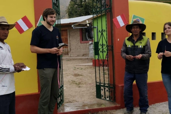 A group of people standing in front of a colorful building