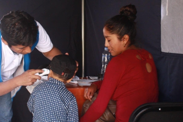 a child getting an injection shot with his mother