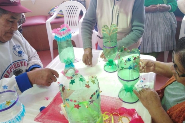 A group of people sitting at a table making crafts