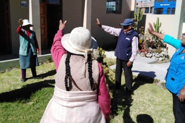 A group of people standing in front of a house