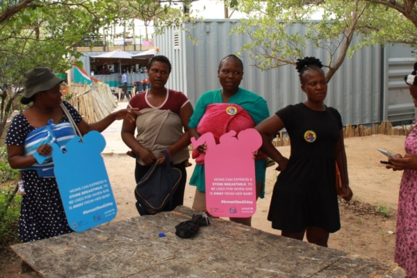 Women with information signs about breastfeeding