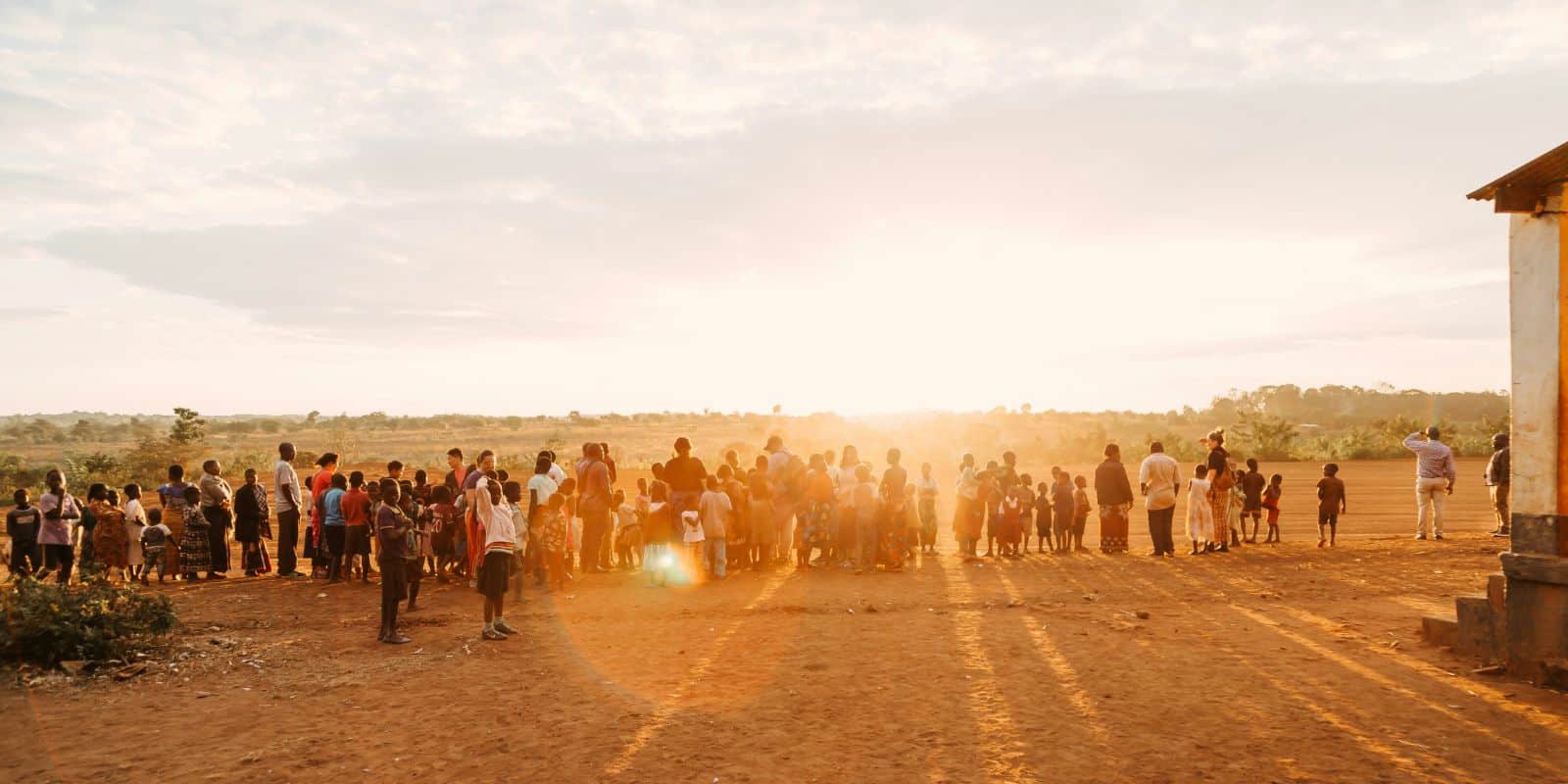 a group of people watching the sun rise in Malawi