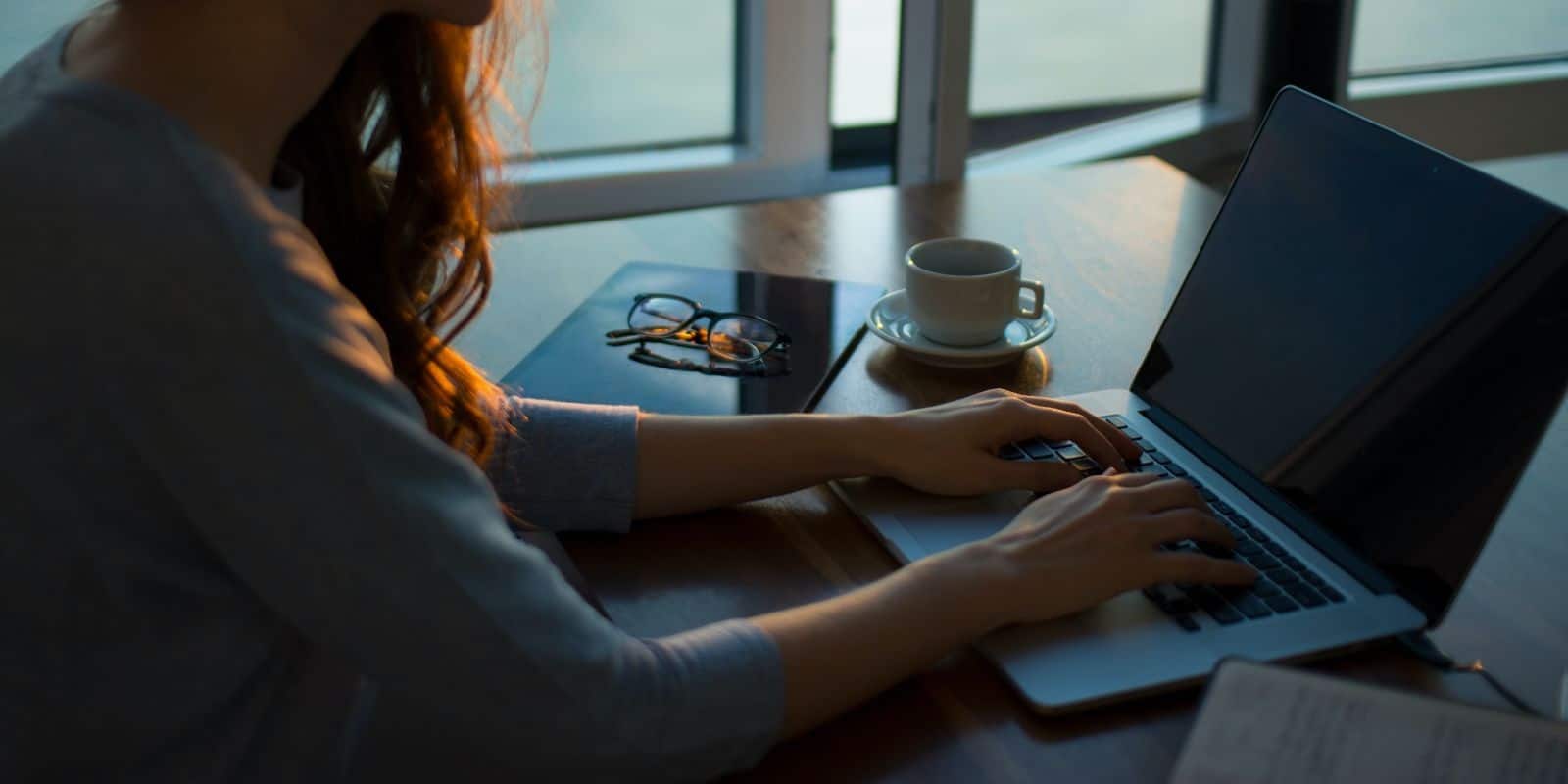 a woman sitting while using laptop