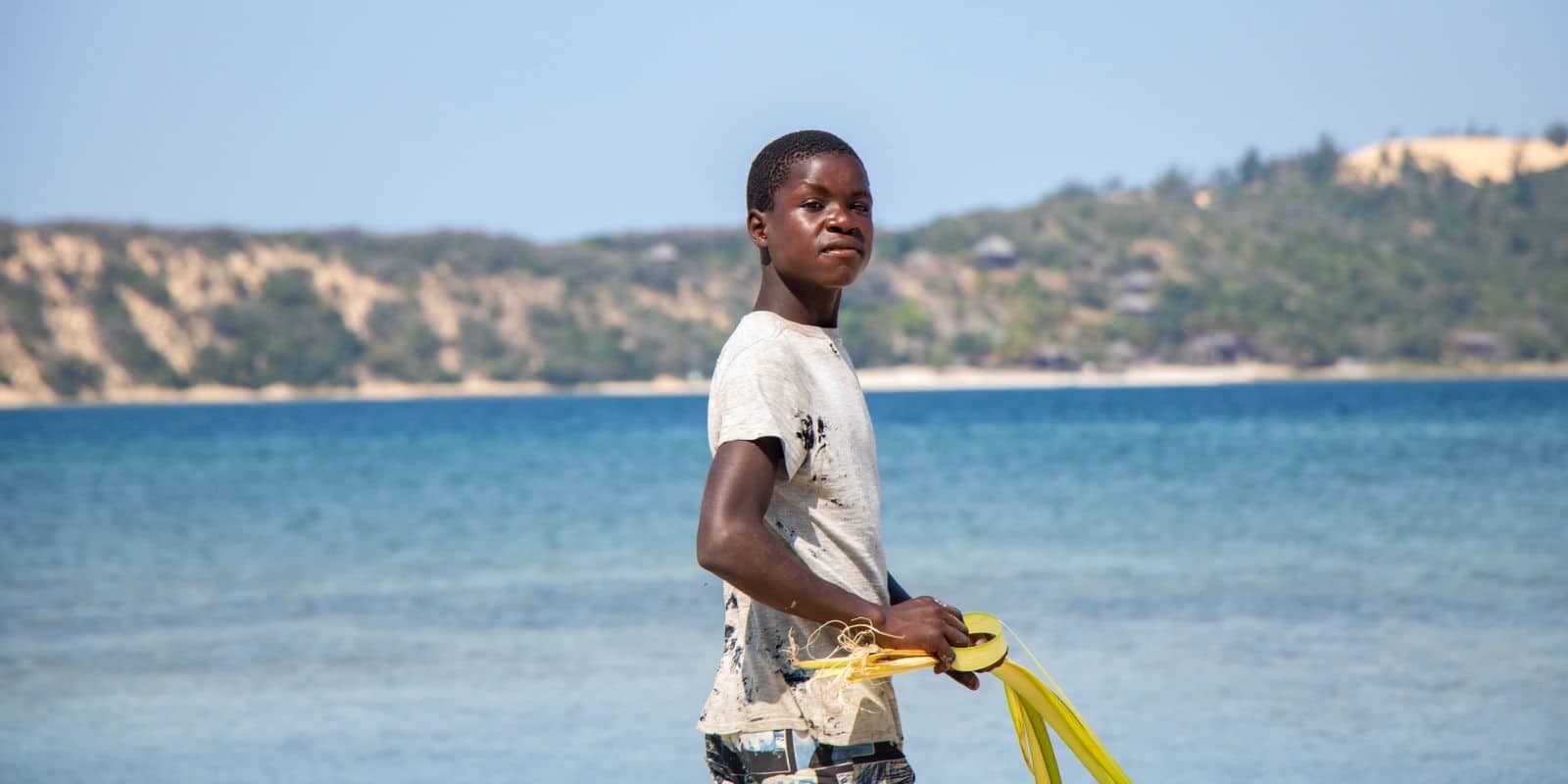 a local kid walking by the beach in Mozambique