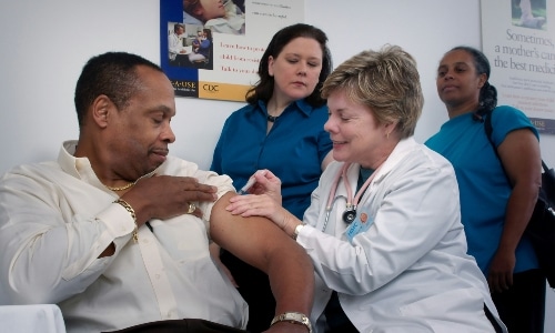 interns watching doctor give a shot