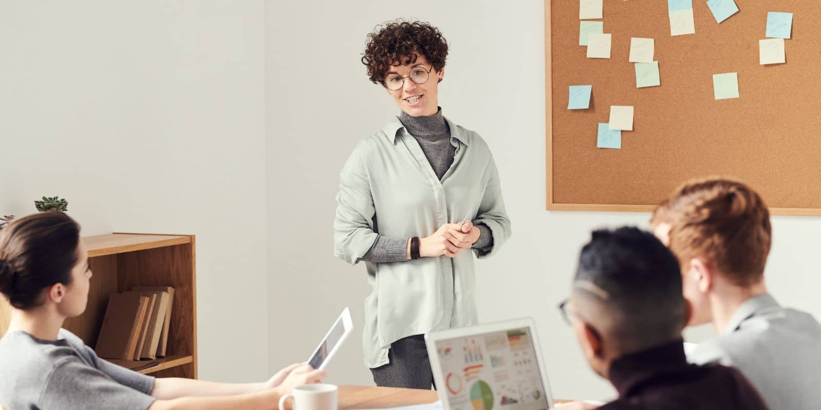 a woman talking in front of a group