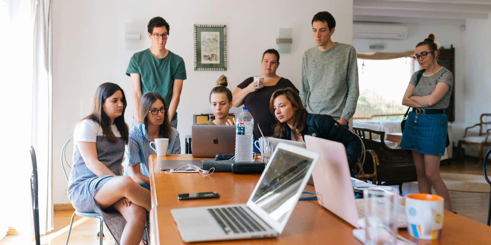 a group of interns watching on a laptop