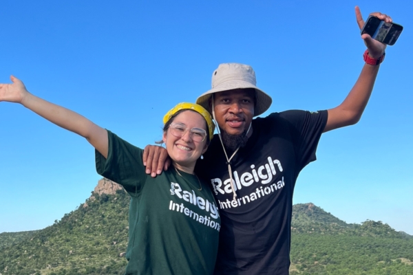 Two people with arms in the air