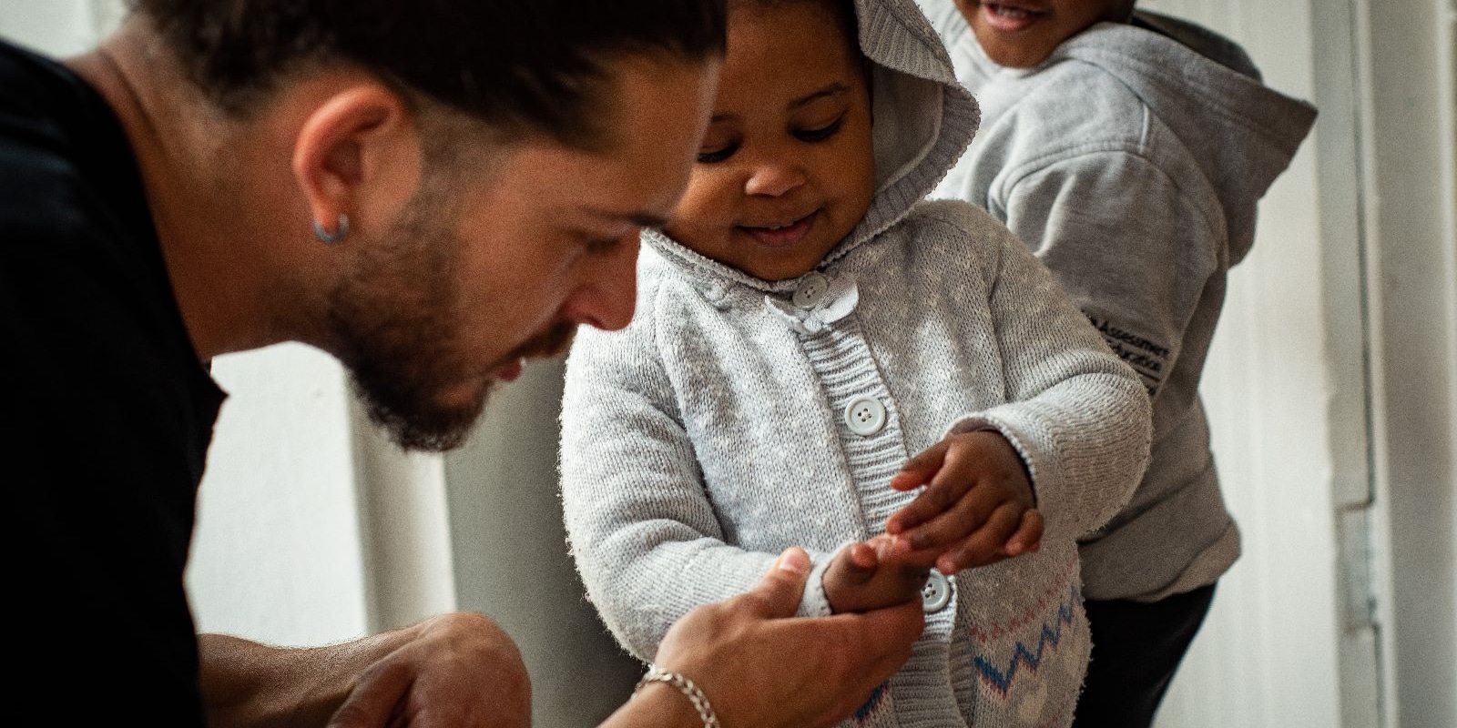 Intern inspecting the hand of a child