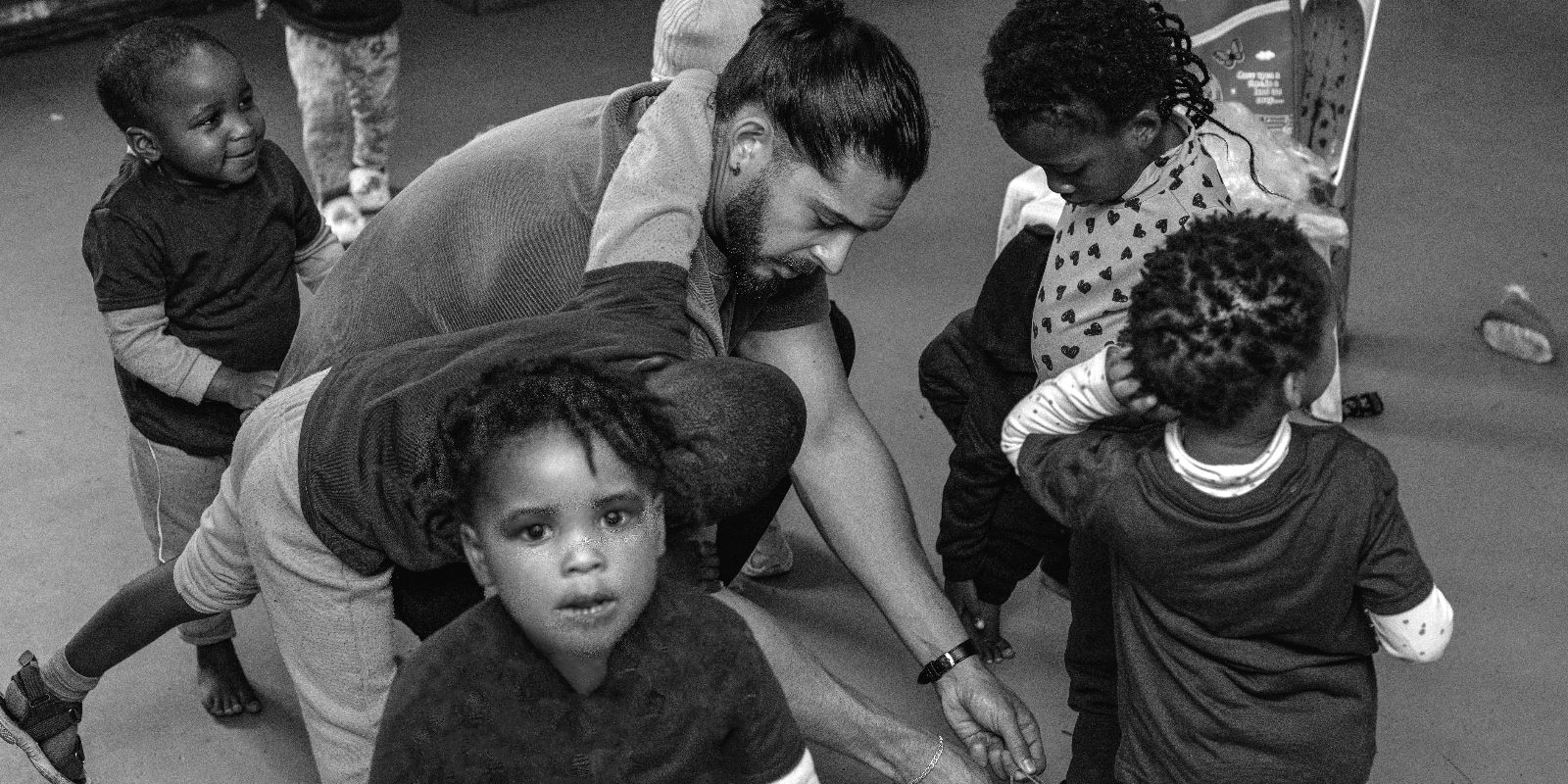 Event management intern playing with kids