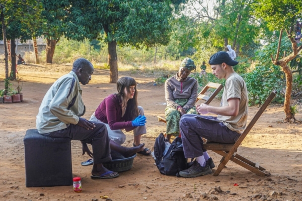 public health interns in zambia meeting with patients