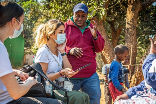 public health intern in zambia speaking with patients