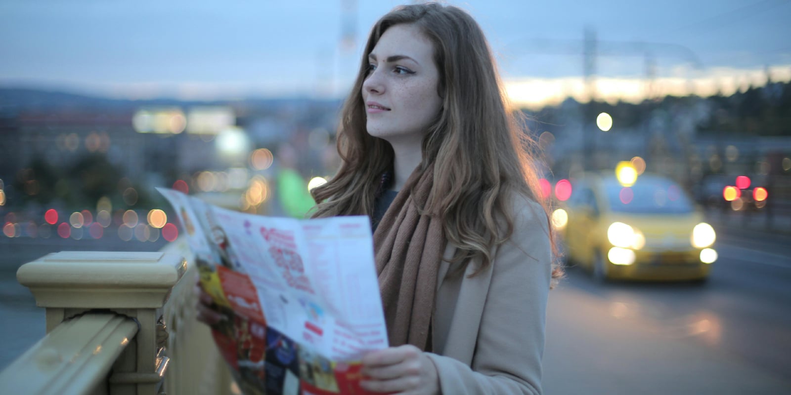 Woman holding a map on the street