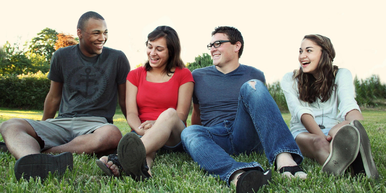 People sitting on grass smiling