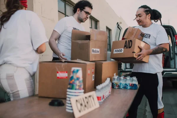 Volunteers organize and distribute aid boxes during a charity event.