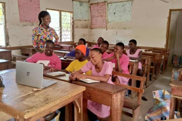 B-GILD participants take notes during a laptop-led session in class, showing their dedication to education and tech-driven growth.