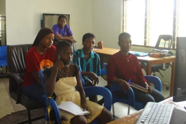Young girls join an interactive online class in a modern learning space, embracing digital literacy and personal development tools.